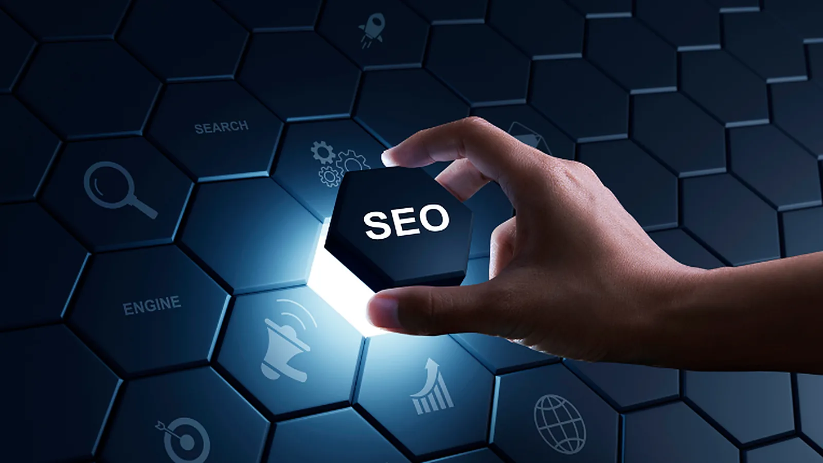 A hand places a glowing SEO tile among search, engine, analytics and global reach icons