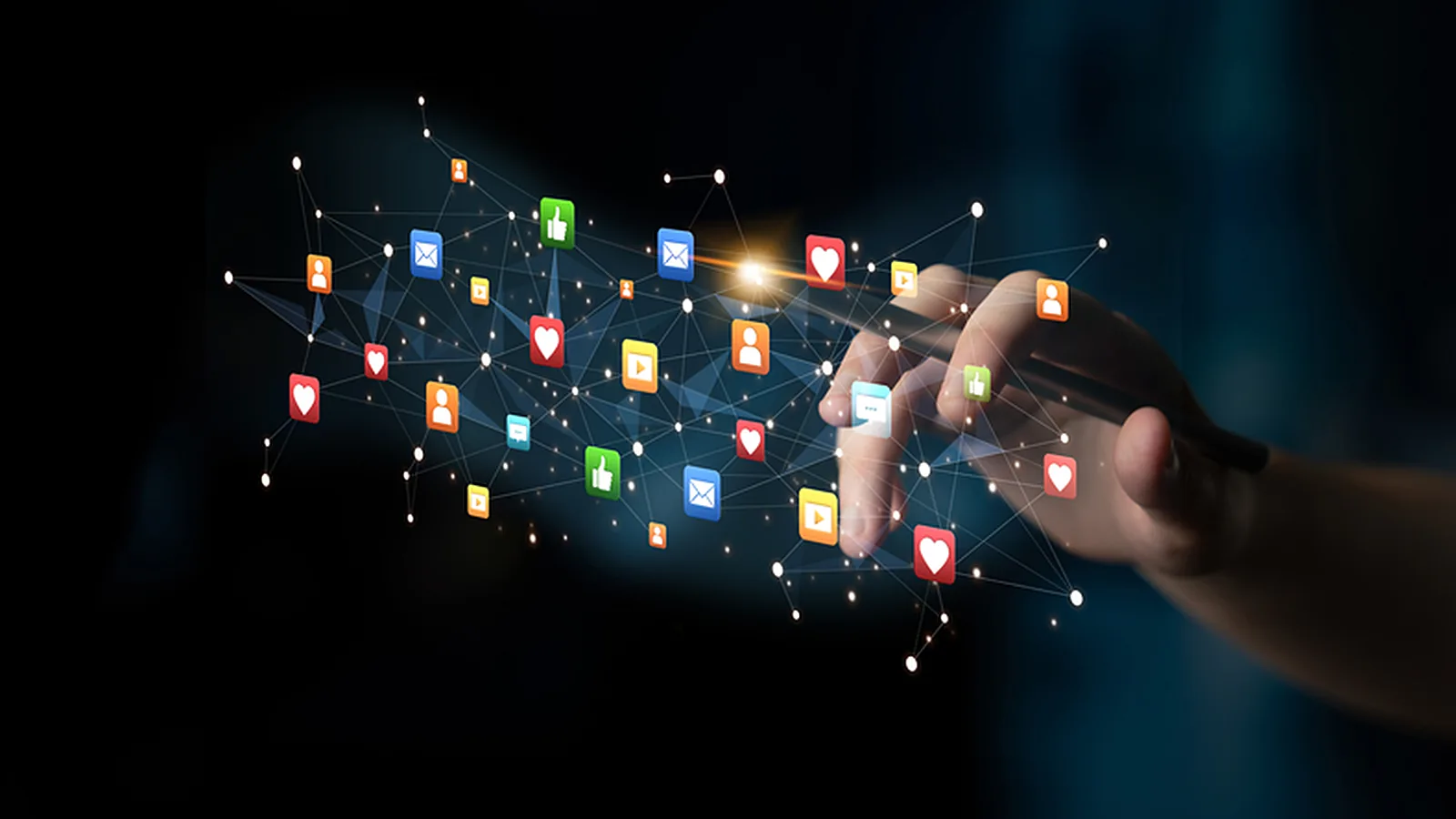 Likes, comments, messages and video icons spreading as a network from a phone in a hand